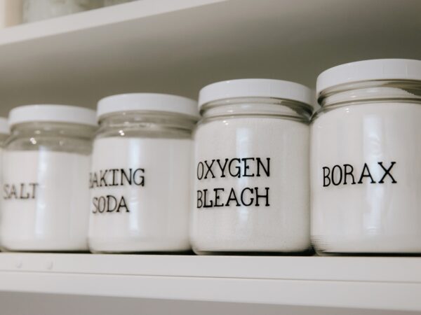 Figgy & Co cleaning supplies stored in glass jars with labels 