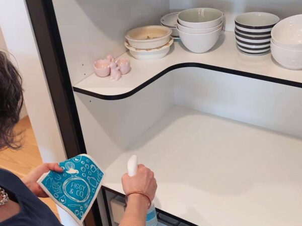Spraying Kitchen cupboard with Figgy & Co's Everyday Spray