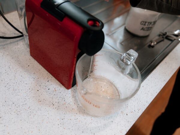 Running Citric Acid mix through a coffee machine to descale it