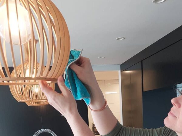 Dusting a lamp shade 