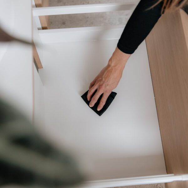 Wiping out Bathroom Drawers after spraying with Figgy & Co's Everyday Spray