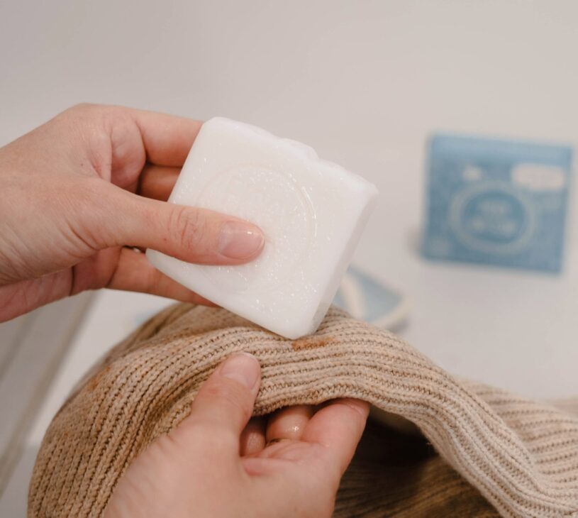 suds up the mark by rubbing the bar soap directly onto the stain